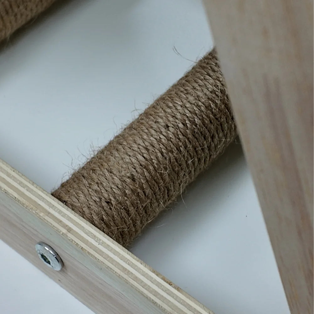 Close-up of a roll of twine inside a wooden frame on a white surface.