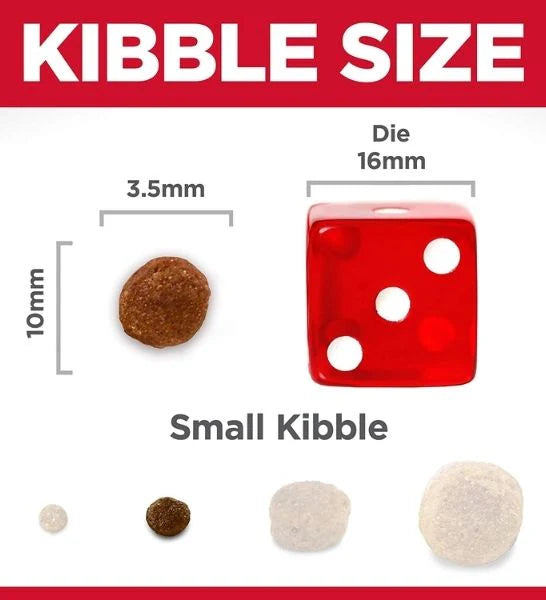 Comparison of small kibble size with a red die showing measurements